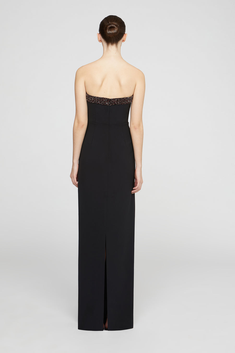 Black strapless evening gown with beaded detailing on a white background
