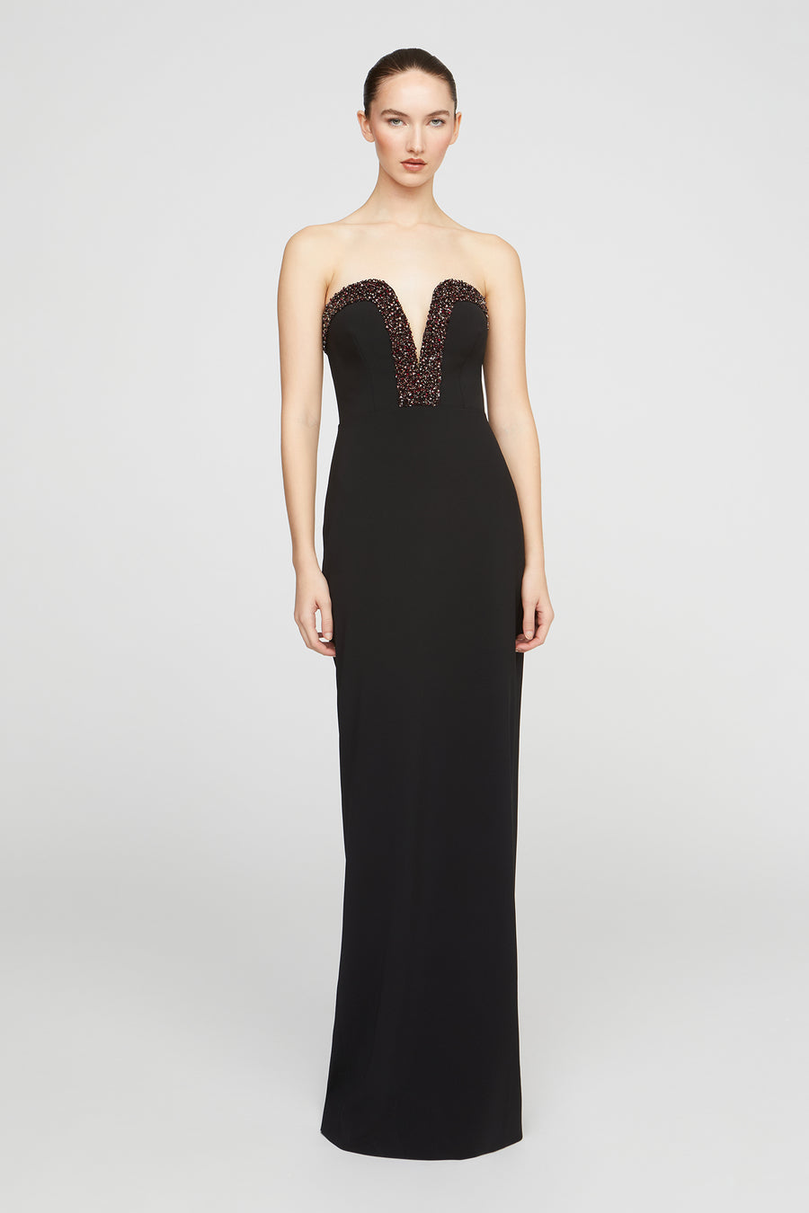Black strapless gown with lace detailing on a white background