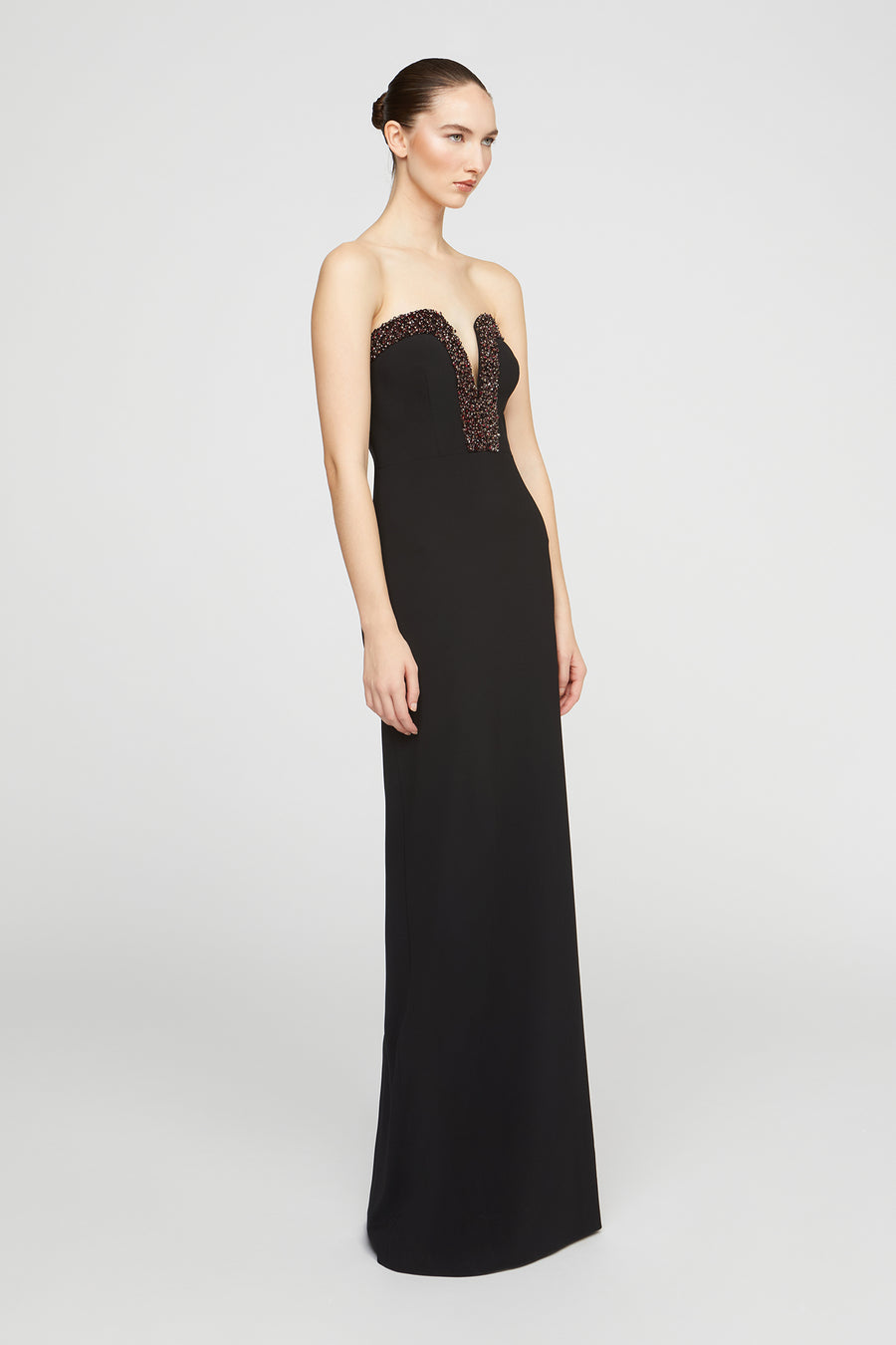 Black strapless evening gown with lace detailing on a white background