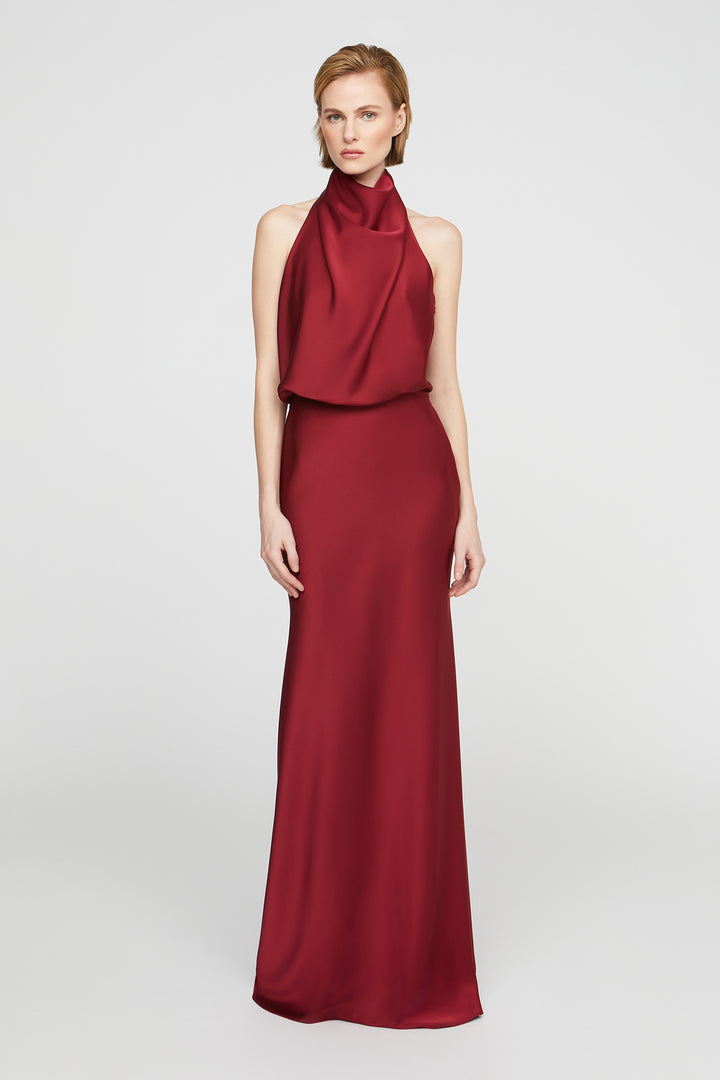 Red evening gown with a halter neck design on a white background