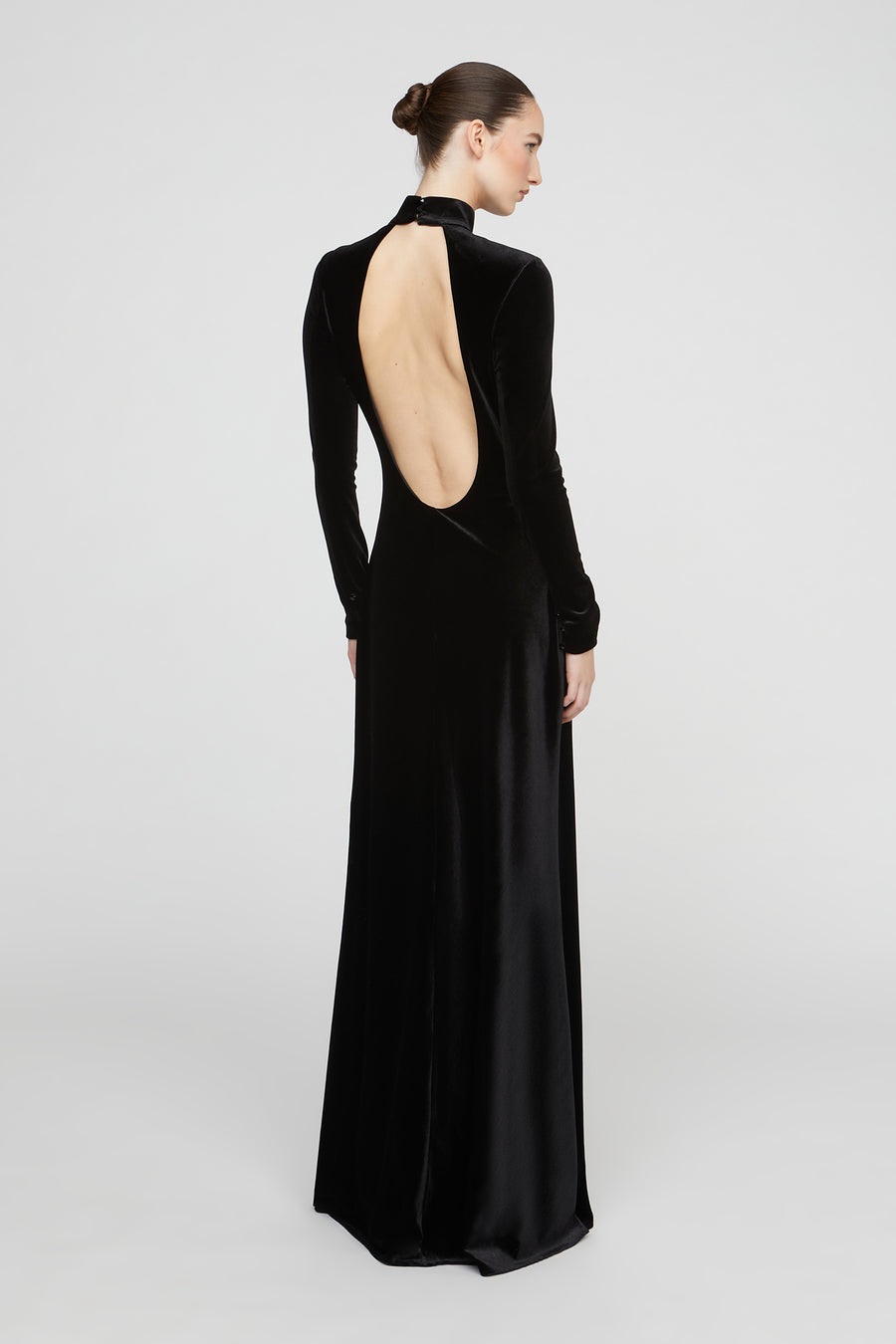 Black evening gown with open back on a white background
