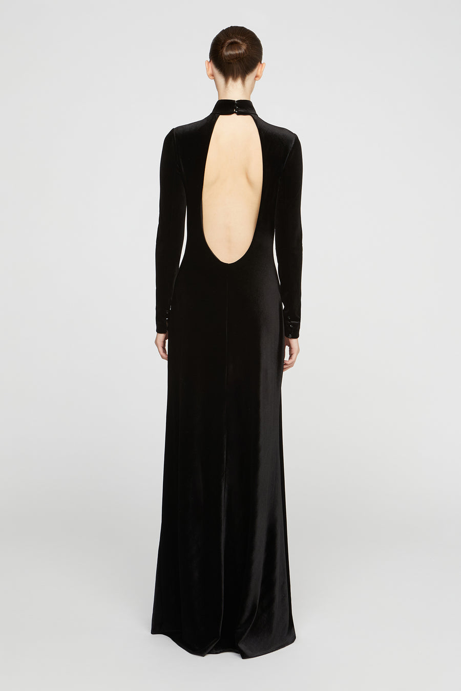 Black evening gown with open back on a white background