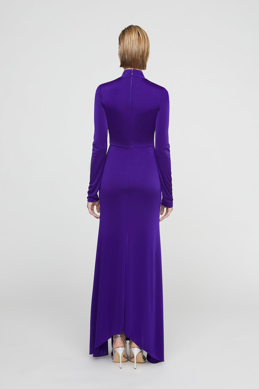 Purple evening gown with long sleeves on a white background