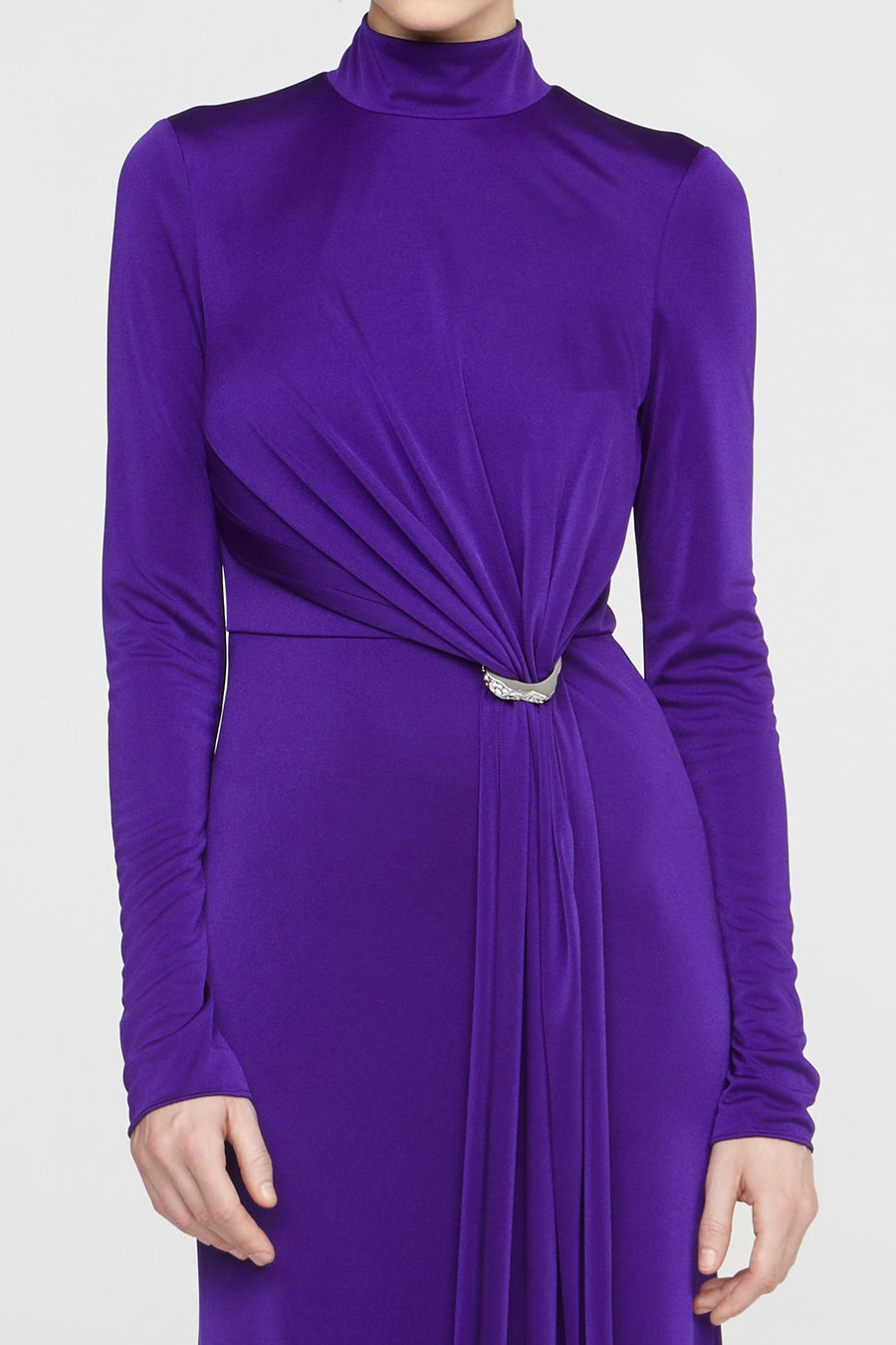 Purple dress with long sleeves and a belt on a white background