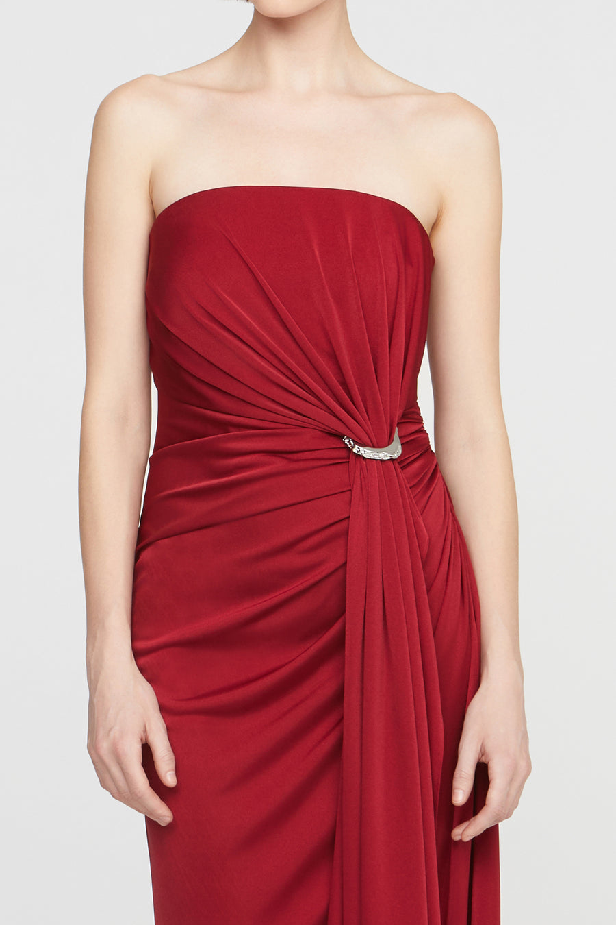 Red strapless dress with a belt on a white background