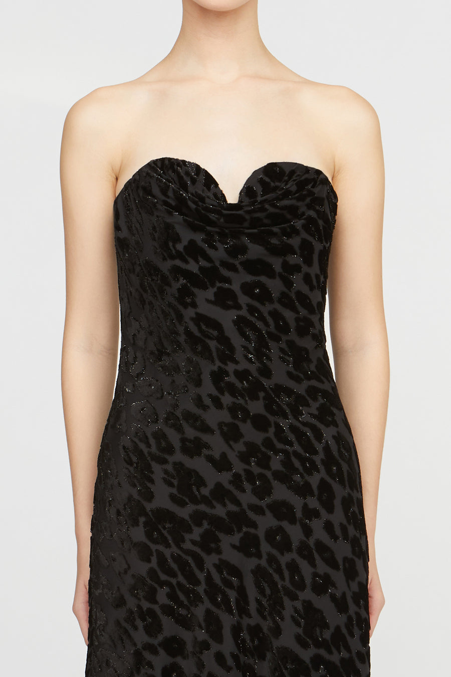Black strapless dress with leopard print pattern on a white background