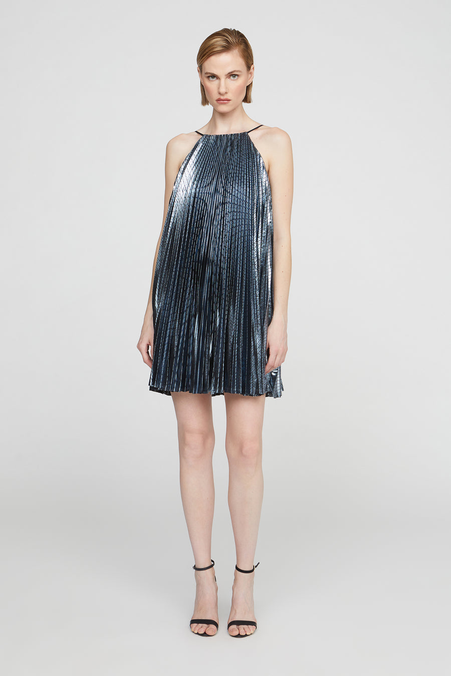 Woman wearing a metallic blue dress on a white background