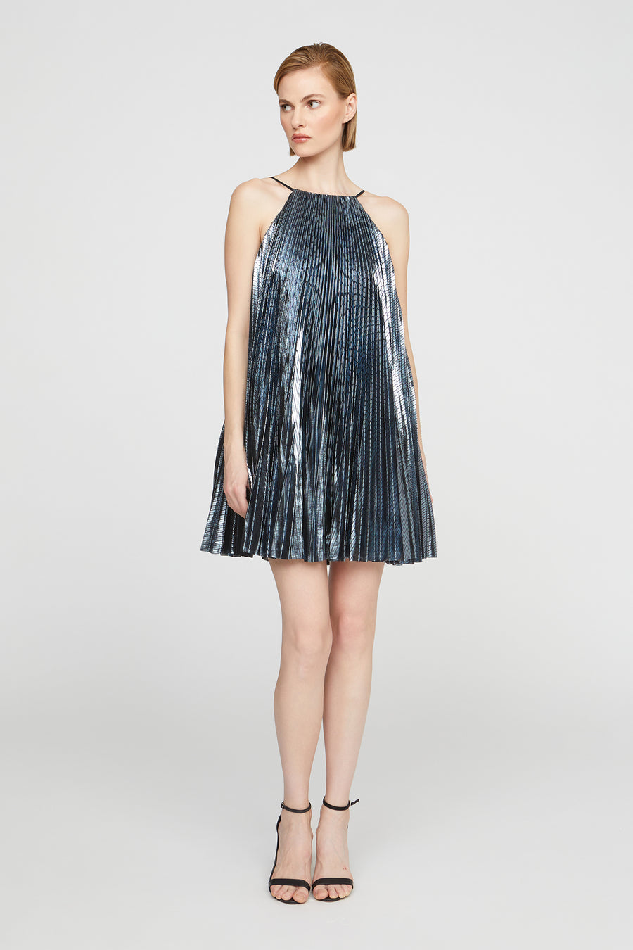 Woman wearing a metallic dress on a white background
