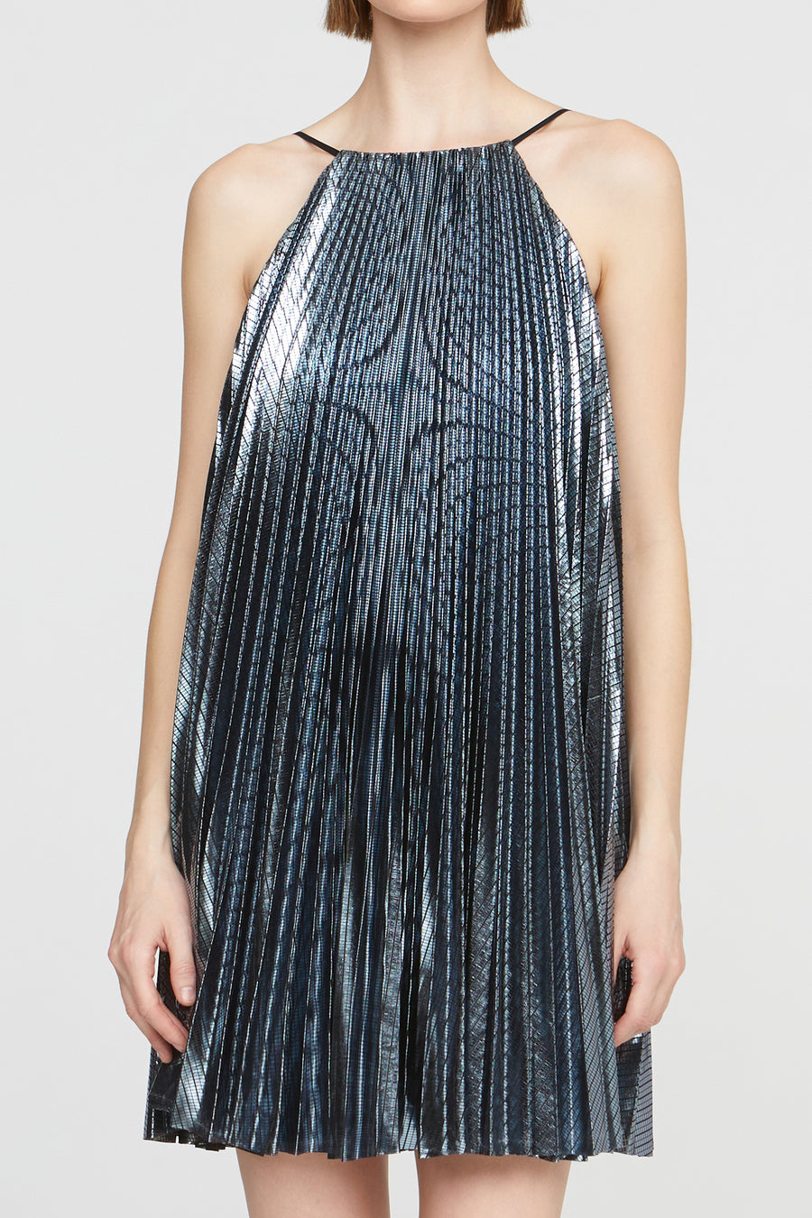 Woman wearing a metallic blue dress on a white background