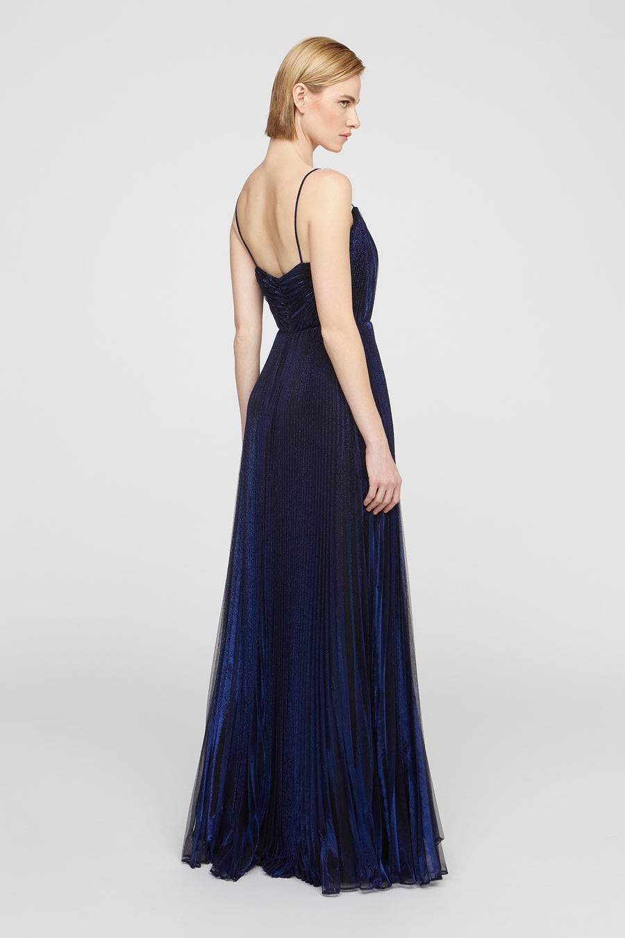 Woman wearing a navy blue evening gown on a white background