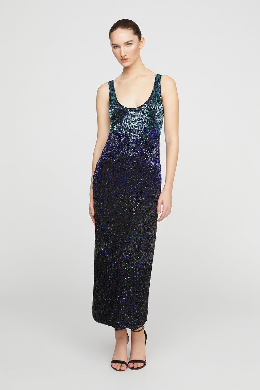 Woman wearing a sequin dress on a white background
